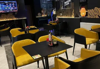 Yellow armchairs and tables in Vrapchester