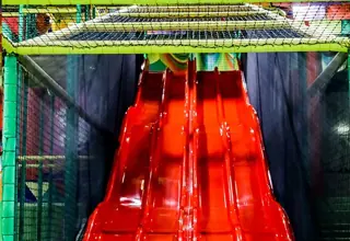 Red slide in the big game room of Family Park