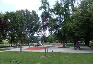 Playground surrounded by trees in the 101st Brigade Park